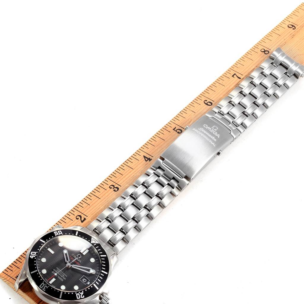 The image shows the Omega Seamaster 212.30.41.20.01.002 Men
s Stainless Steel Black Dial 212.30.41.20.01.002 Men
s Stainless Steel Black Dial watch lying flat on a ruler, displaying its face, bezel, bracelet, and clasp.