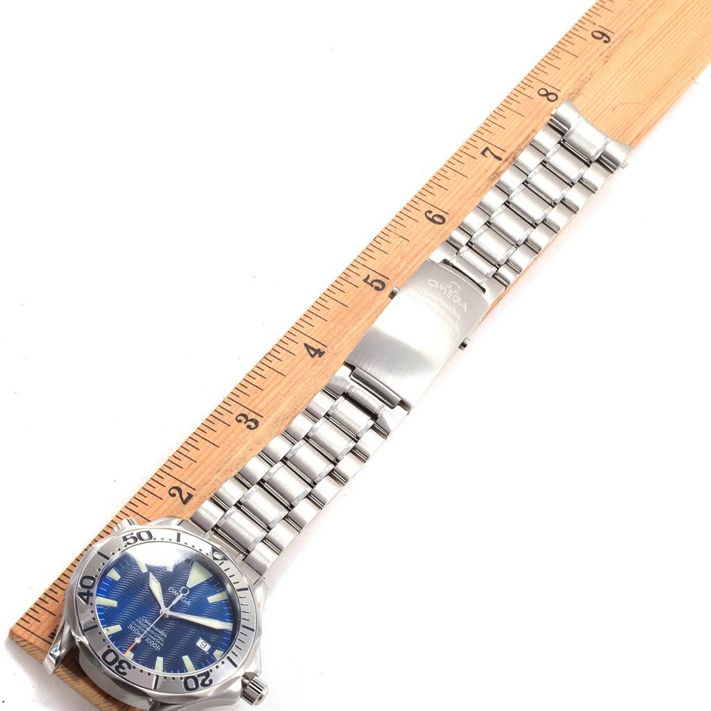 The image shows an Omega Seamaster 2255.80.00 Men
s Stainless Steel Blue Dial 2255.80.00 Men
s Stainless Steel Blue Dial watch placed next to a ruler, displaying its face and metal bracelet.