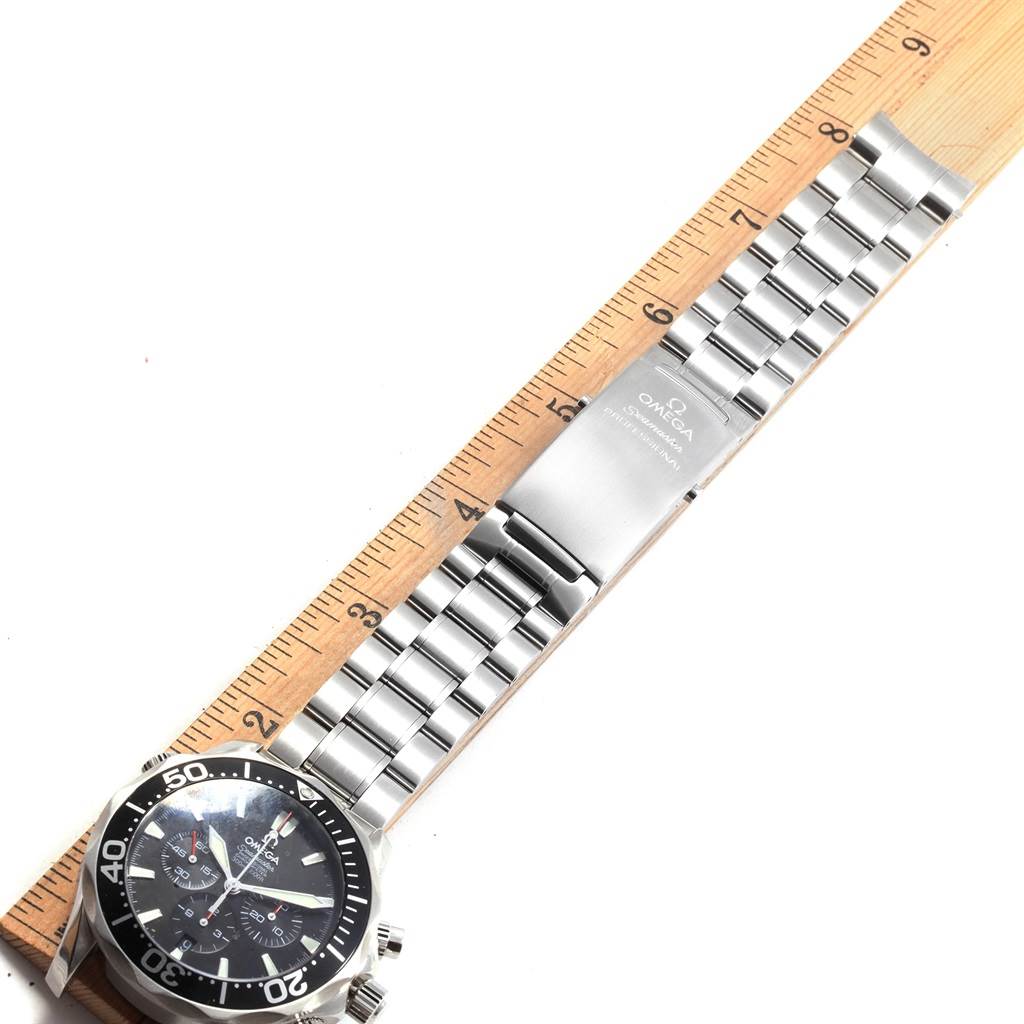 The image shows an Omega Seamaster 2594.52.00 Men
s Stainless Steel Black Dial 2594.52.00 Men
s Stainless Steel Black Dial watch laid flat, displaying the face, bracelet, clasp, and part of a ruler for measurement.