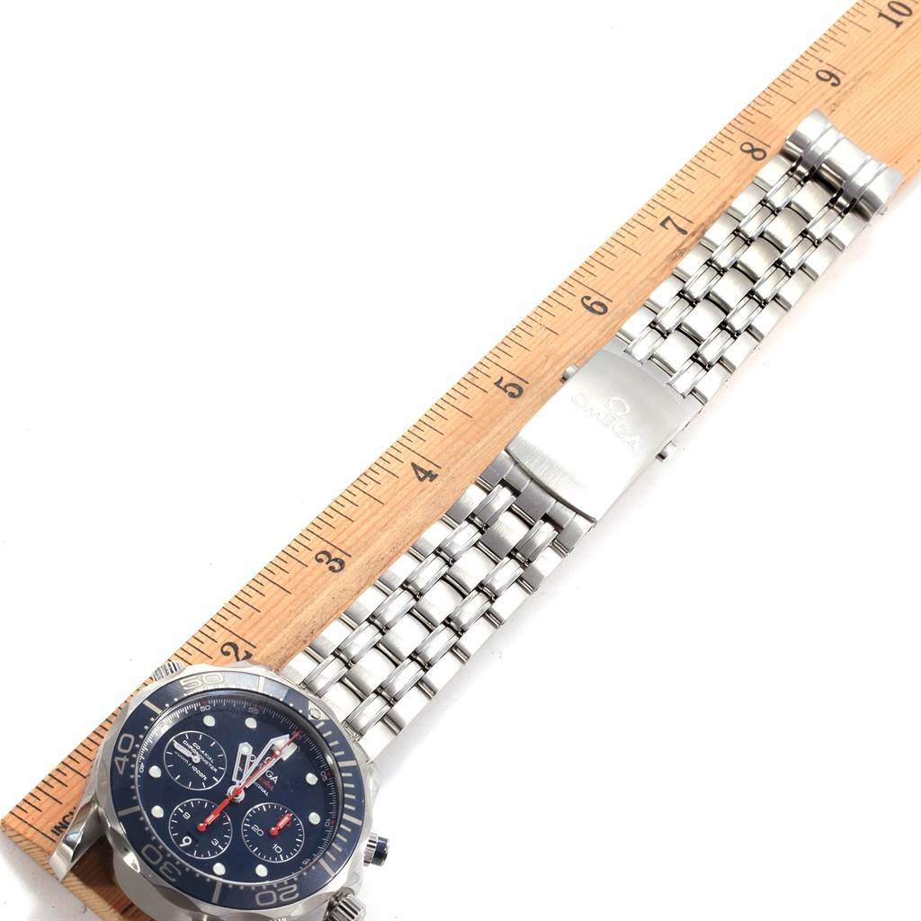 The image shows an overhead view of an Omega Seamaster 212.30.44.50.03.001 Men
s Stainless Steel Blue Dial 212.30.44.50.03.001 Men
s Stainless Steel Blue Dial watch, focusing on the watch face and bracelet up to the clasp, alongside a ruler.