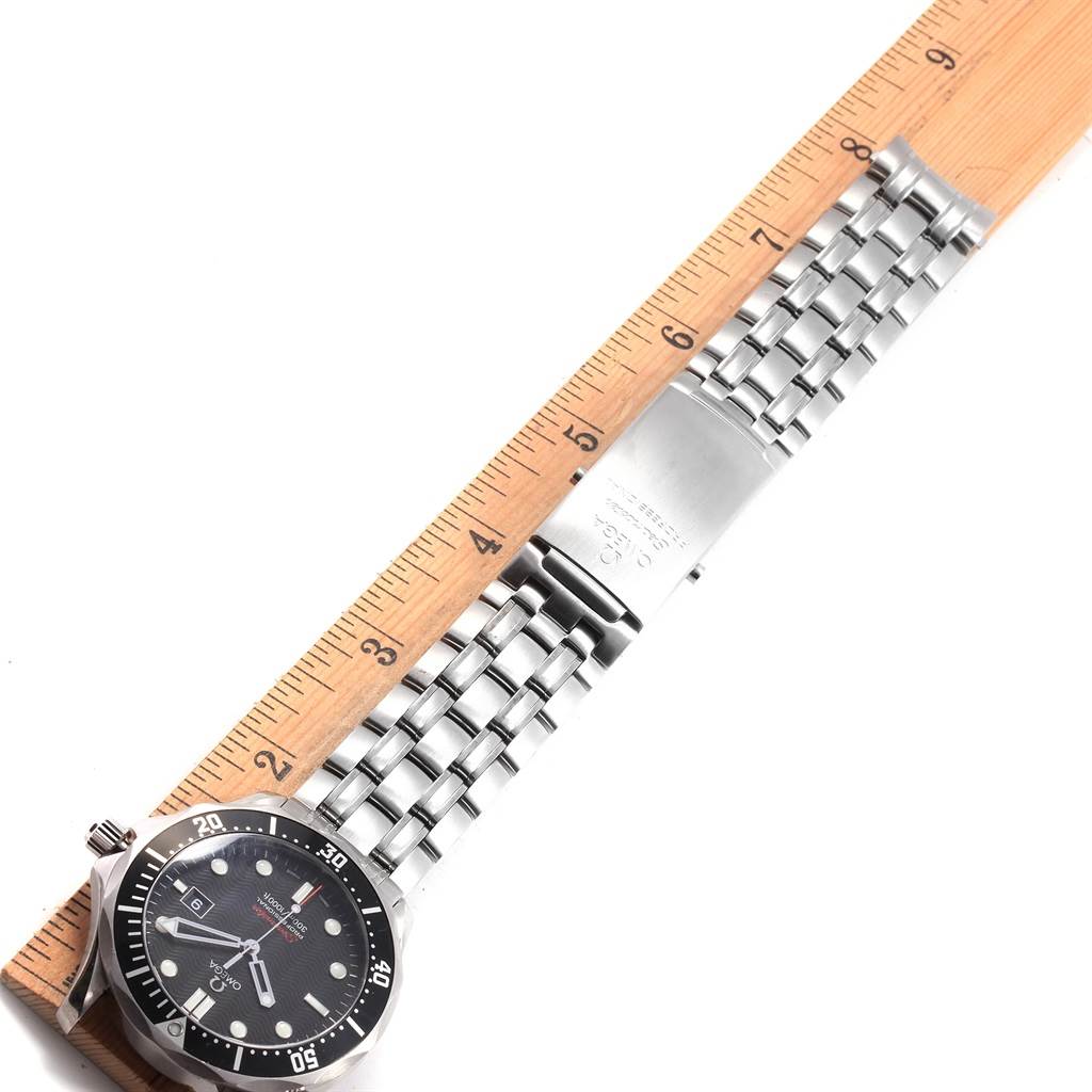 The image shows an Omega Seamaster 212.30.41.61.01.001 Men
s Stainless Steel Black Dial 212.30.41.61.01.001 Men
s Stainless Steel Black Dial watch laid flat with its metal bracelet aligned beside a wooden ruler.