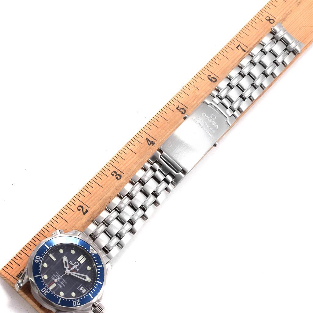 This image shows an overhead view of the Omega Seamaster 2222.80.00 Men
s Stainless Steel Blue Dial 2222.80.00 Men
s Stainless Steel Blue Dial watch, highlighting its blue bezel, dial, and metal bracelet with a ruler for scale.