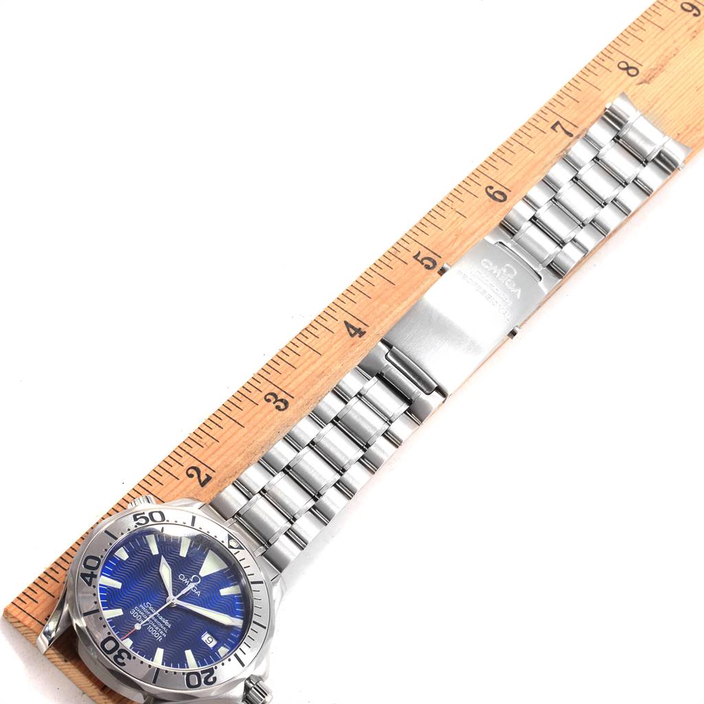 The image shows an Omega Seamaster 2255.80.00 Men
s Stainless Steel Blue Dial 2255.80.00 Men
s Stainless Steel Blue Dial watch laid flat next to a ruler, displaying the watch face and metal bracelet.