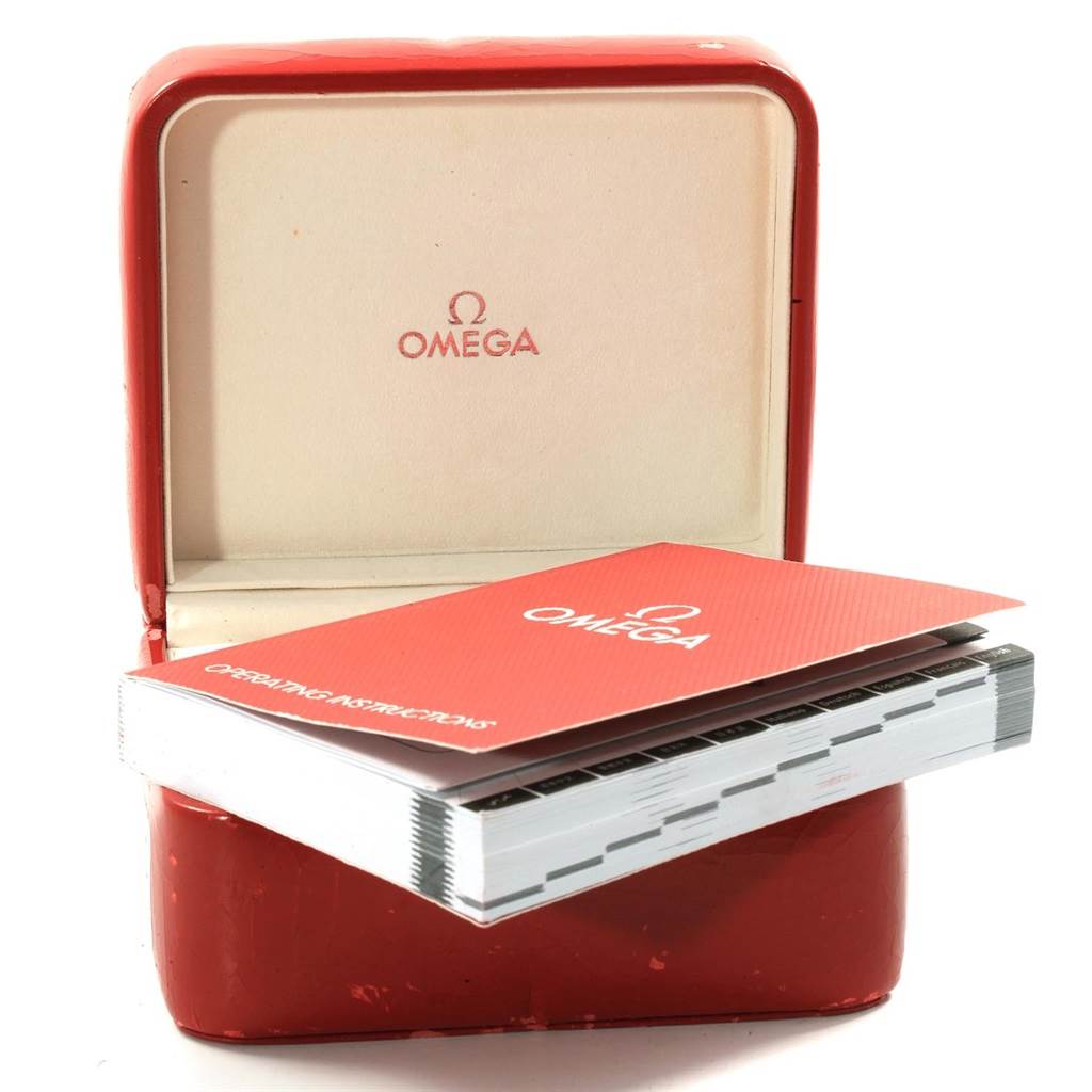 The image shows an Omega watch box with a Seamaster model instruction manual placed on top of it.