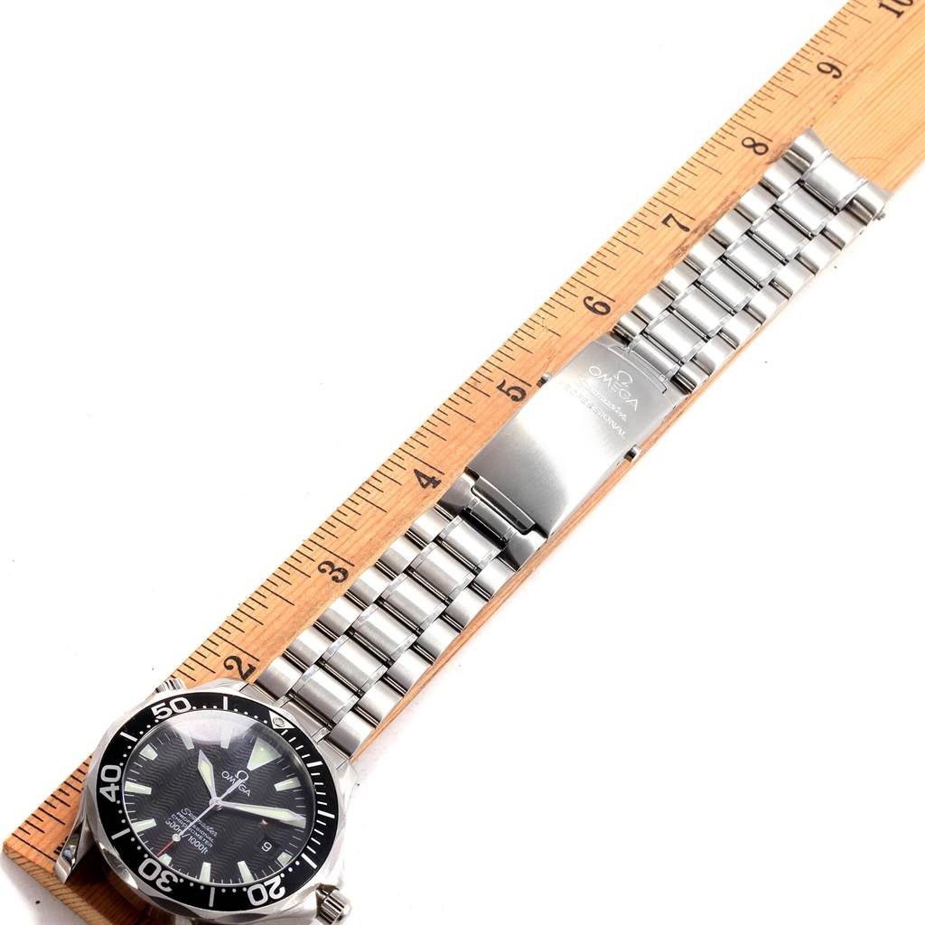 The image shows an Omega Seamaster 2254.50.00 Men
s Stainless Steel Black Dial 2254.50.00 Men
s Stainless Steel Black Dial watch lying flat next to a ruler, highlighting its face, bezel, crown, and stainless steel bracelet.
