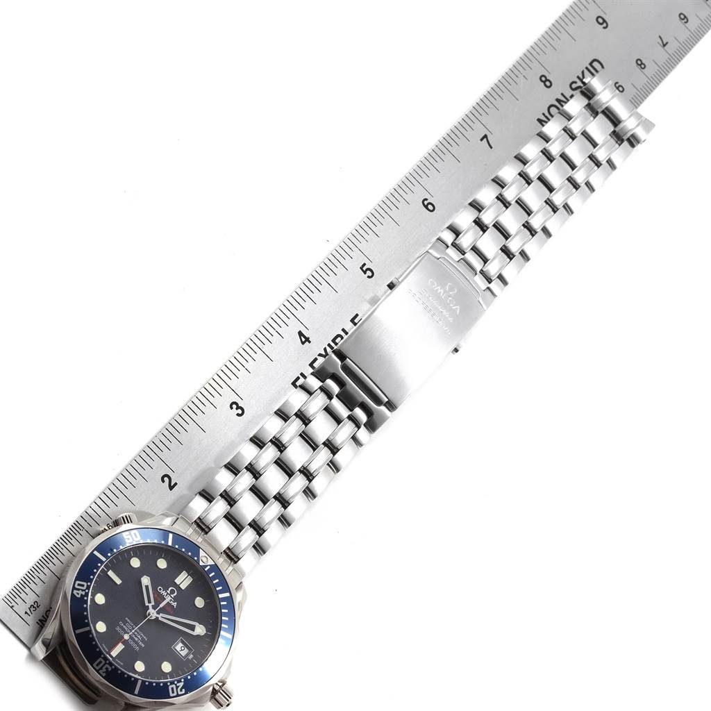 The image shows the Omega Seamaster 2220.80.00 Men
s Stainless Steel Blue Dial 2220.80.00 Men
s Stainless Steel Blue Dial watch from a top-down angle, highlighting its blue bezel, black dial, and metal bracelet next to a ruler.