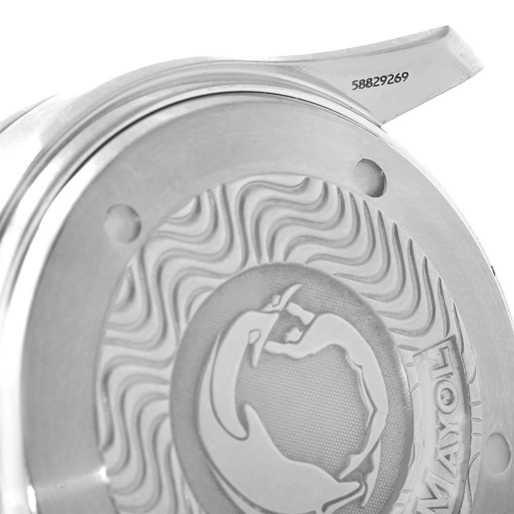 The image shows the back casing of an Omega Seamaster 2595.30.00 Men
s Stainless Steel Silver Dial 2595.30.00 Men
s Stainless Steel Silver Dial watch, highlighting the decorative engravings and serial number.