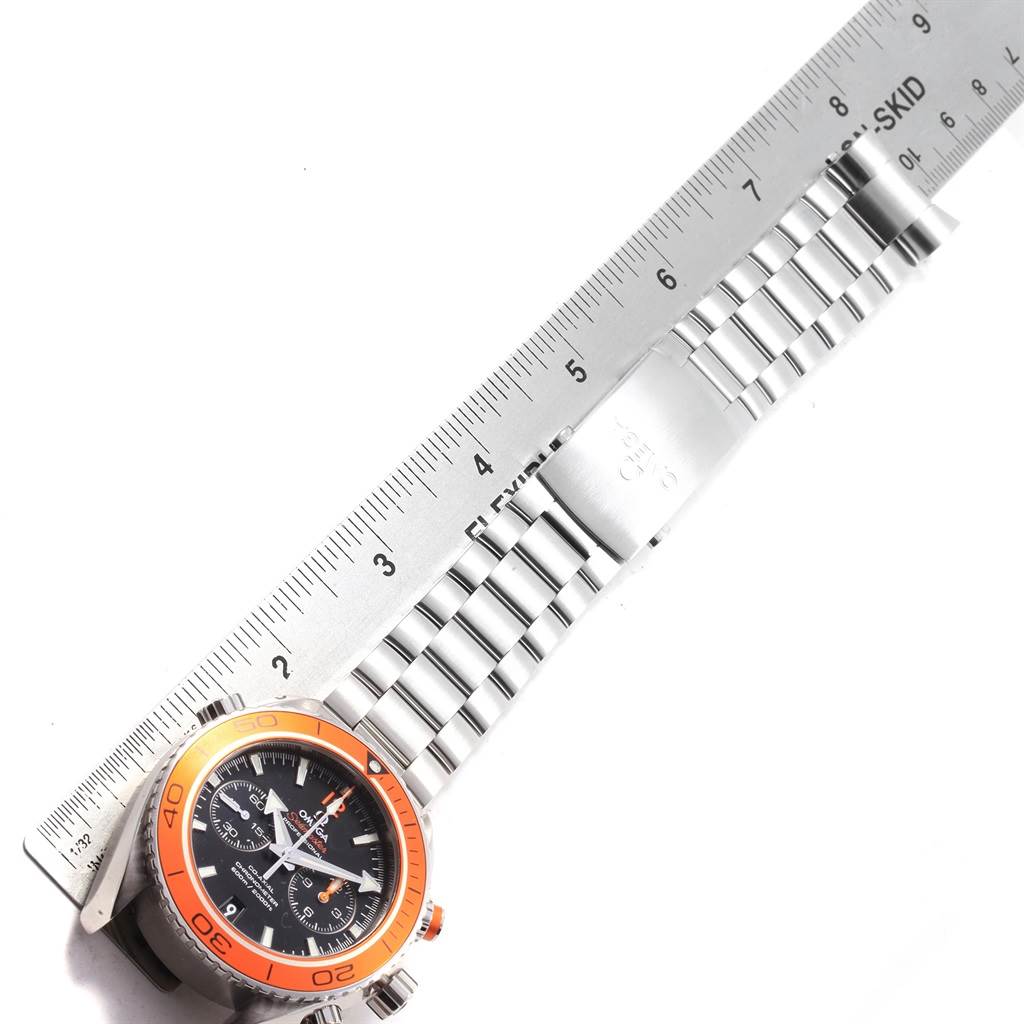 The Omega Seamaster 232.30.46.51.01.002 Men
s Stainless Steel Black Dial 232.30.46.51.01.002 Men
s Stainless Steel Black Dial watch is shown from above, displaying the watch face, bezel, and stainless steel bracelet along with a ruler for scale.