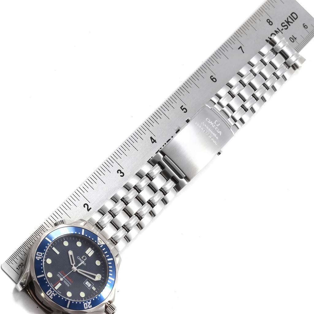 The image shows an Omega Seamaster 2221.80.00 Men
s Stainless Steel Blue Dial 2221.80.00 Men
s Stainless Steel Blue Dial watch with a stainless steel bracelet and clasp, measured against a ruler.