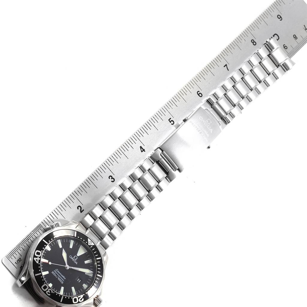 The image shows an Omega Seamaster 2264.50.00 Men
s Stainless Steel Black Dial 2264.50.00 Men
s Stainless Steel Black Dial watch laid flat next to a ruler, highlighting the stainless steel bracelet and clasp.