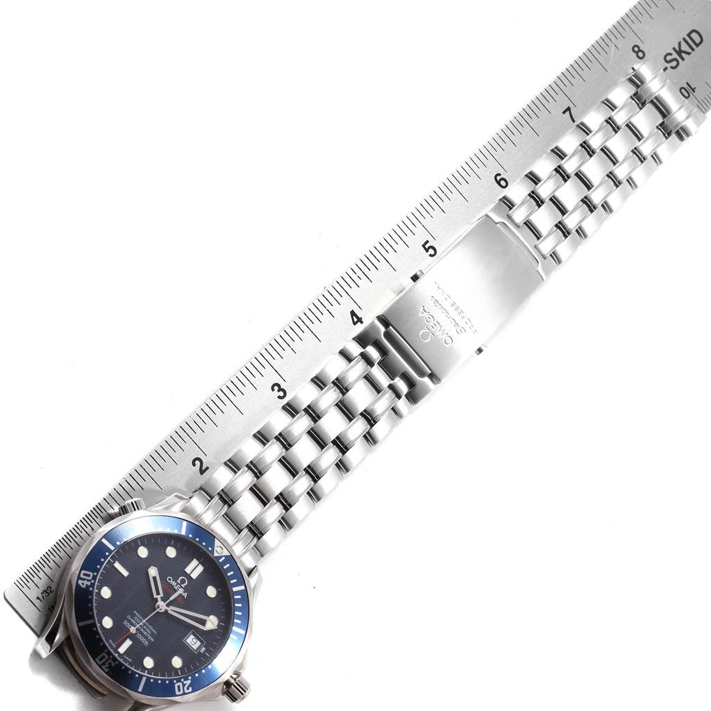 The image shows an Omega Seamaster 2220.80.00 Men
s Stainless Steel Blue Dial 2220.80.00 Men
s Stainless Steel Blue Dial watch at an overhead angle, showcasing its face, bezel, bracelet, and clasp alongside a ruler for scale.