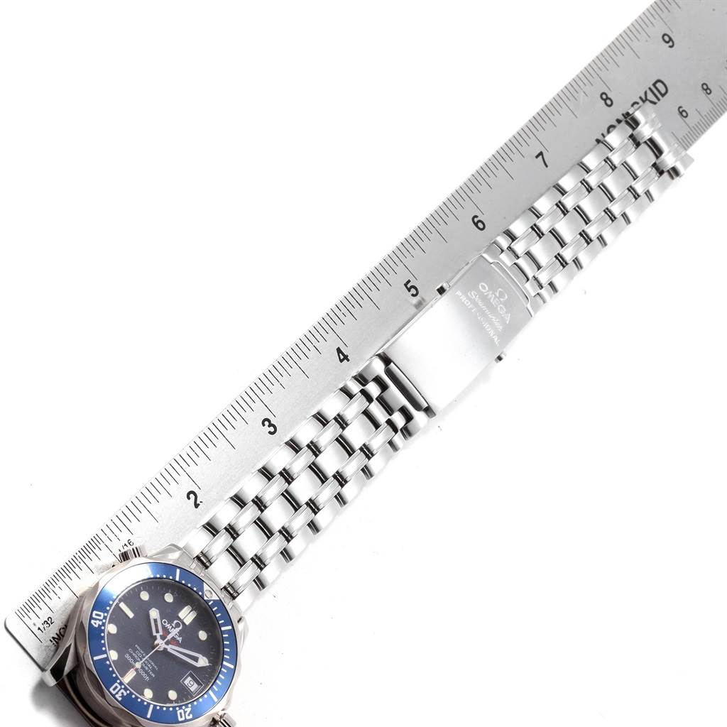 The image shows a top-down view of an Omega Seamaster 2222.80.00 Men
s Stainless Steel Blue Dial 2222.80.00 Men
s Stainless Steel Blue Dial watch, focusing on the bracelet and clasp beside a ruler.