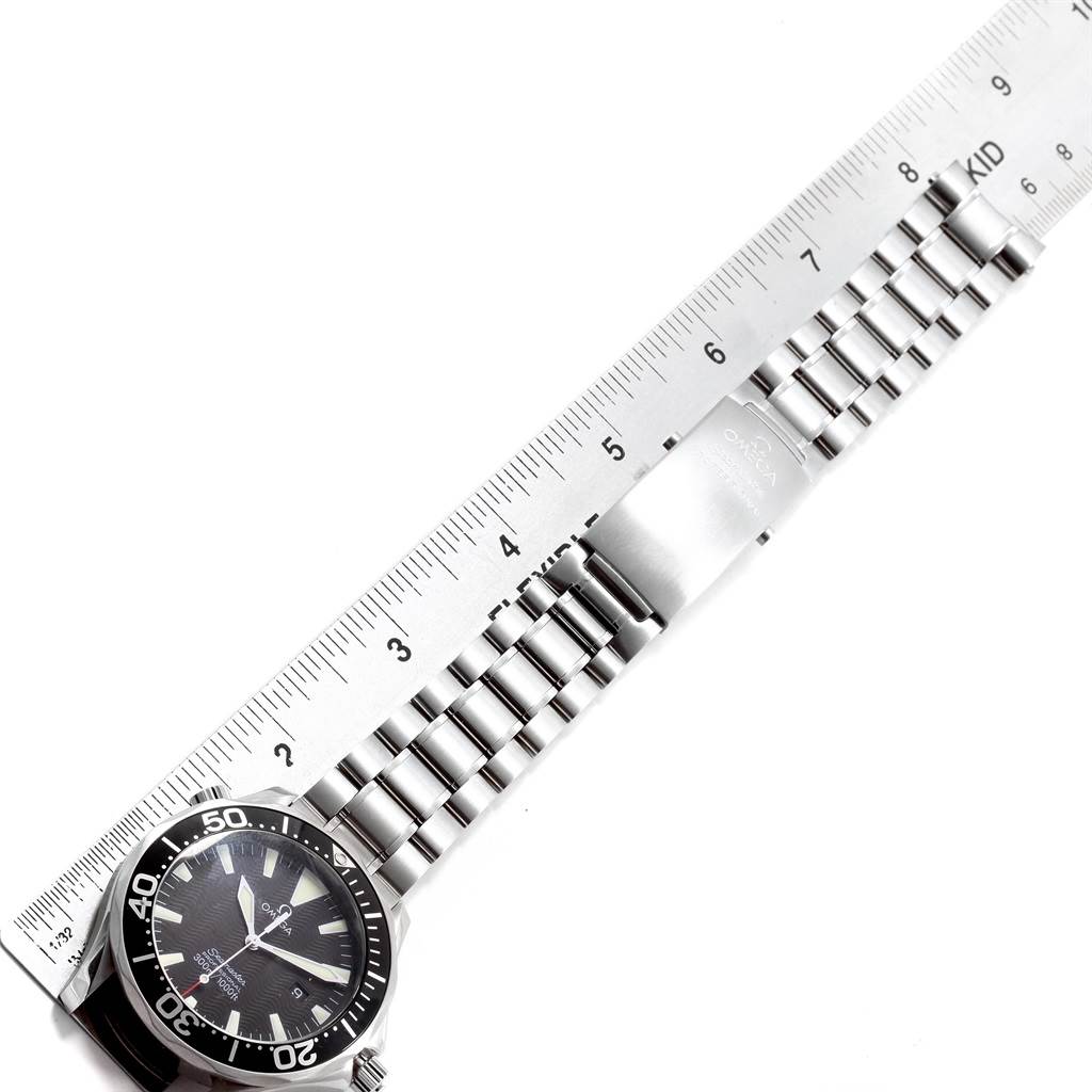 The image shows the Omega Seamaster 2264.50.00 Men
s Stainless Steel Black Dial 2264.50.00 Men
s Stainless Steel Black Dial watch laid flat, with its metal bracelet and clasp, alongside a ruler for measurement.