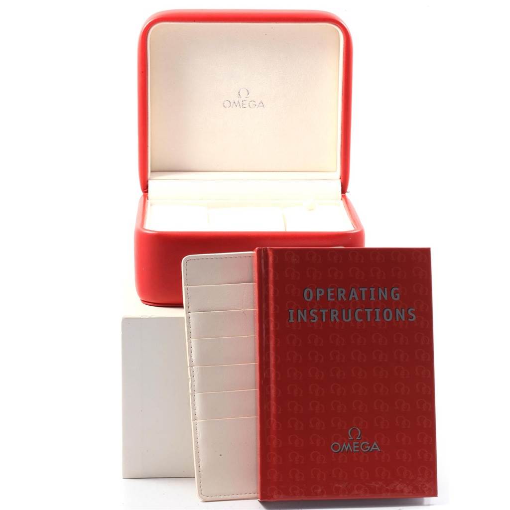 The image shows the Omega Seamaster 2513.30.00 Men
s Stainless Steel Silver Dial 2513.30.00 Men
s Stainless Steel Silver Dial watch accessories, including its red box, instruction manual, and cardholder, with a frontal view.