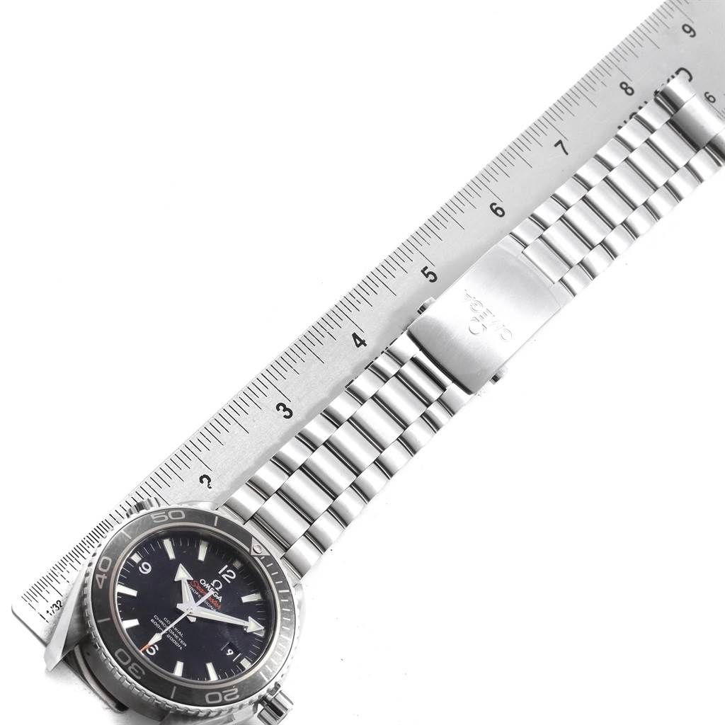 The image shows an Omega Seamaster 232.30.46.21.01.001 Men
s Stainless Steel Black Dial 232.30.46.21.01.001 Men
s Stainless Steel Black Dial watch laid flat, with its metal bracelet and clasp next to a ruler for measurement.