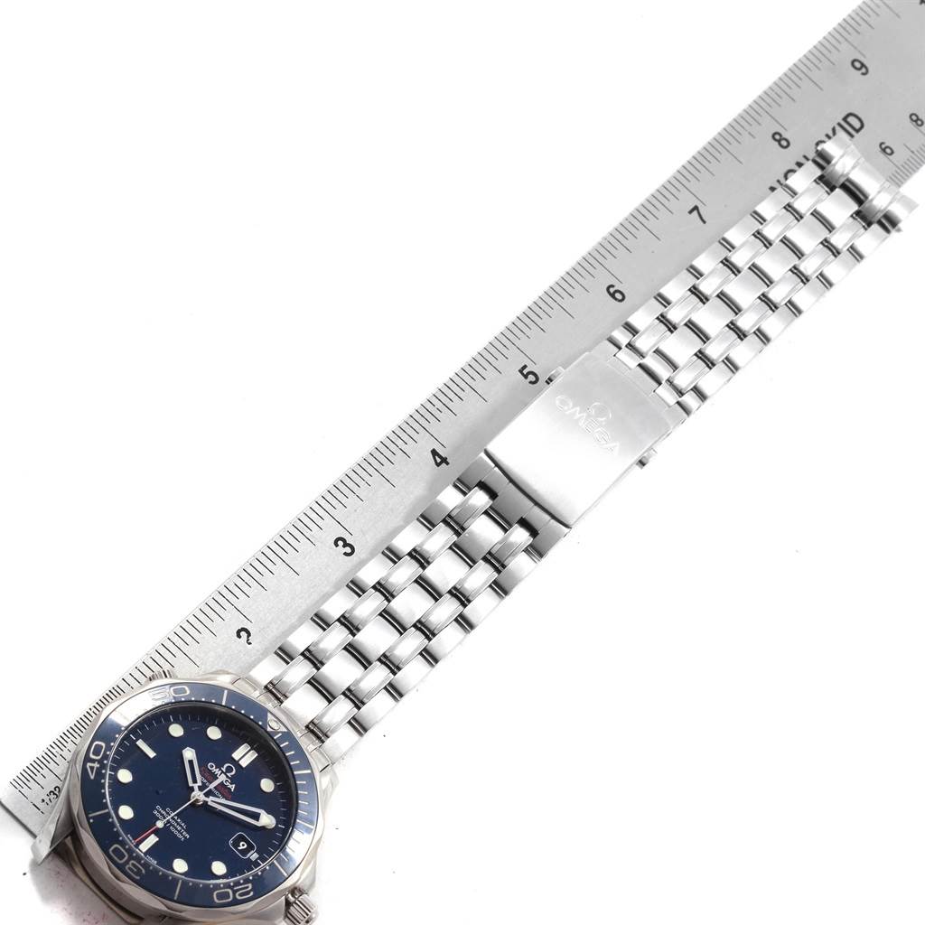 The image shows an Omega Seamaster 212.30.41.20.03.001 Men
s Stainless Steel Blue Dial 212.30.41.20.03.001 Men
s Stainless Steel Blue Dial watch laid flat, with a visible face and stainless steel bracelet next to a ruler for size reference.