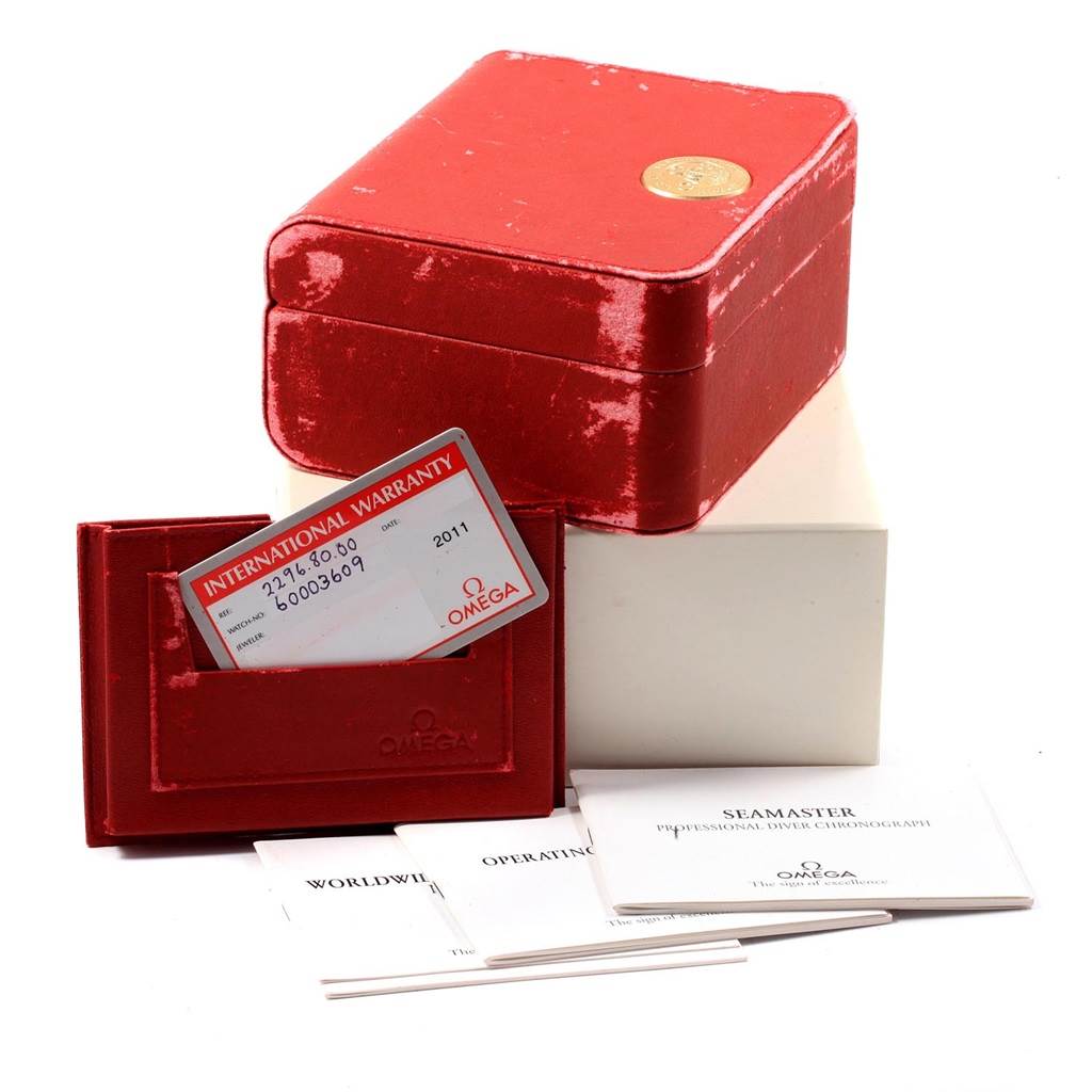 The image shows the packaging and accessories for an Omega Seamaster 2296.80.00 Men
s Titanium Blue Dial 2296.80.00 Men
s Titanium Blue Dial watch, including a red box, warranty card, and manuals.