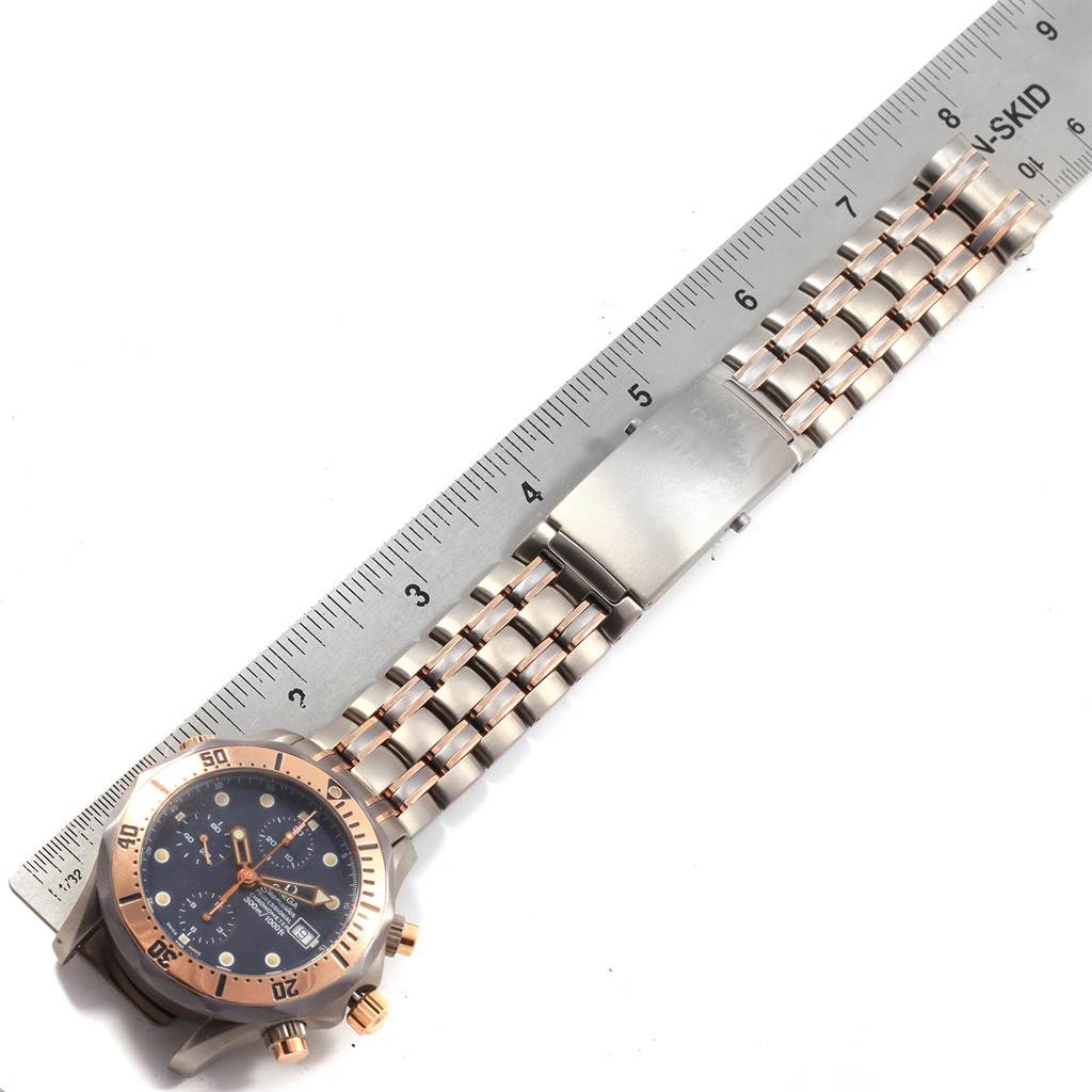 This image shows the Omega Seamaster 2296.80.00 Men
s Titanium Blue Dial 2296.80.00 Men
s Titanium Blue Dial watch laid flat, displaying its face, bezel, and metal bracelet next to a ruler for measurement.