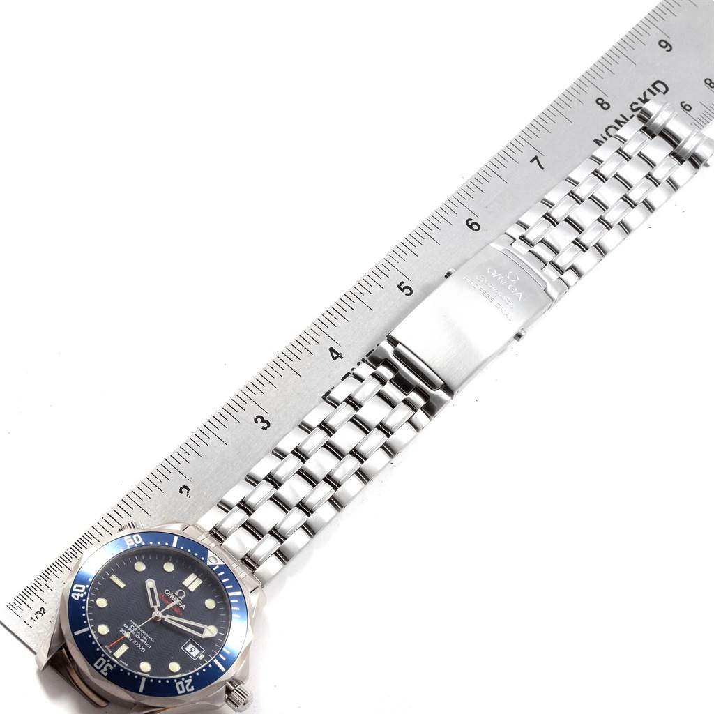 This image shows an Omega Seamaster 2220.80.00 Men
s Stainless Steel Blue Dial 2220.80.00 Men
s Stainless Steel Blue Dial watch with a metal band and clasp, angled alongside a ruler.