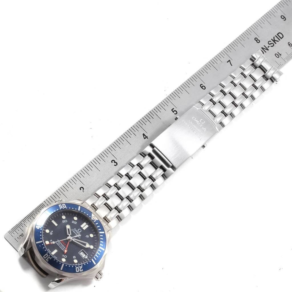 The image shows an Omega Seamaster 2535.80.00 Men
s Blue Dial 2535.80.00 Men
s Blue Dial watch laid flat with its metal bracelet beside a ruler for scale.