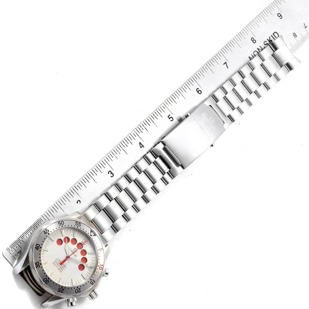 The Omega Seamaster 2595.30.00 Men
s Stainless Steel Silver Dial 2595.30.00 Men
s Stainless Steel Silver Dial watch is shown from a top-down angle, displaying the face, bracelet, and clasp alongside a ruler.