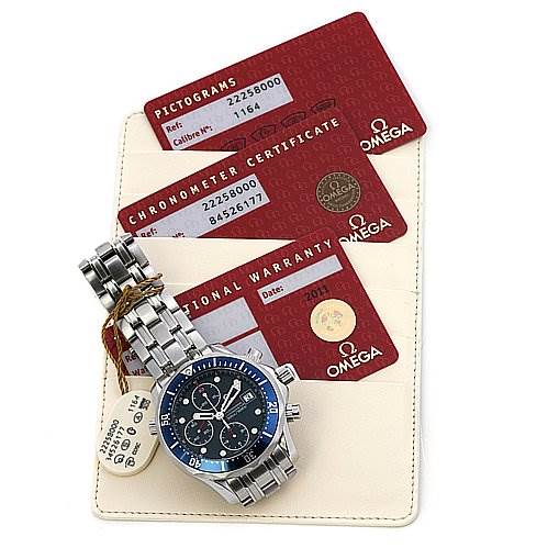 The image shows an Omega Seamaster 22258000 OR 2225.   80.   00 Men's Stainless Steel Blue Dial 22258000 OR 2225.   80.   00 Men's Stainless Steel Blue Dial watch and its accessories, including warranty and certification cards, viewed from a top-down angle.