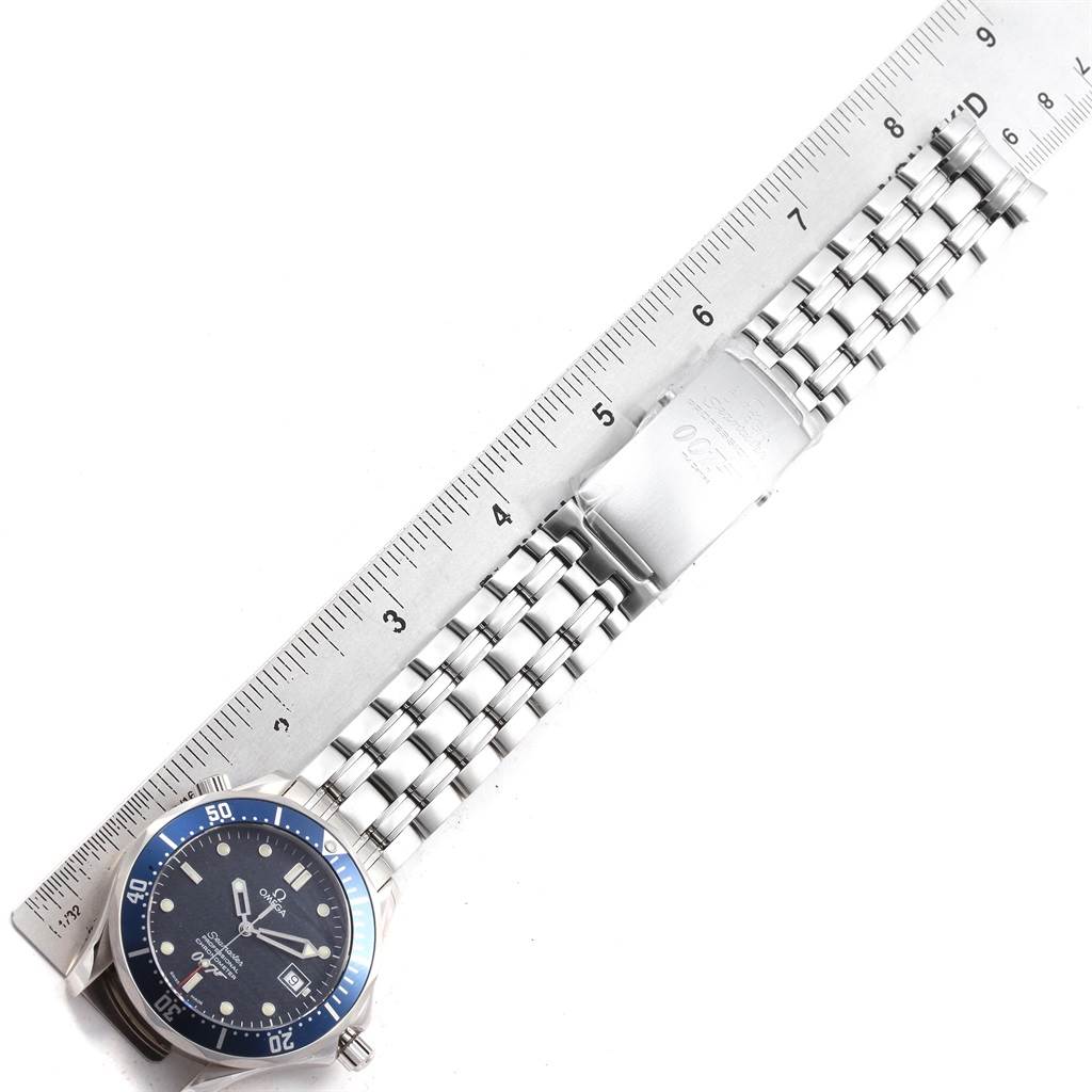 The image shows an Omega Seamaster 2537.80.00 Men
s Stainless Steel Blue Dial 2537.80.00 Men
s Stainless Steel Blue Dial watch laid flat with a ruler beside it, highlighting the face, bezel, and bracelet.