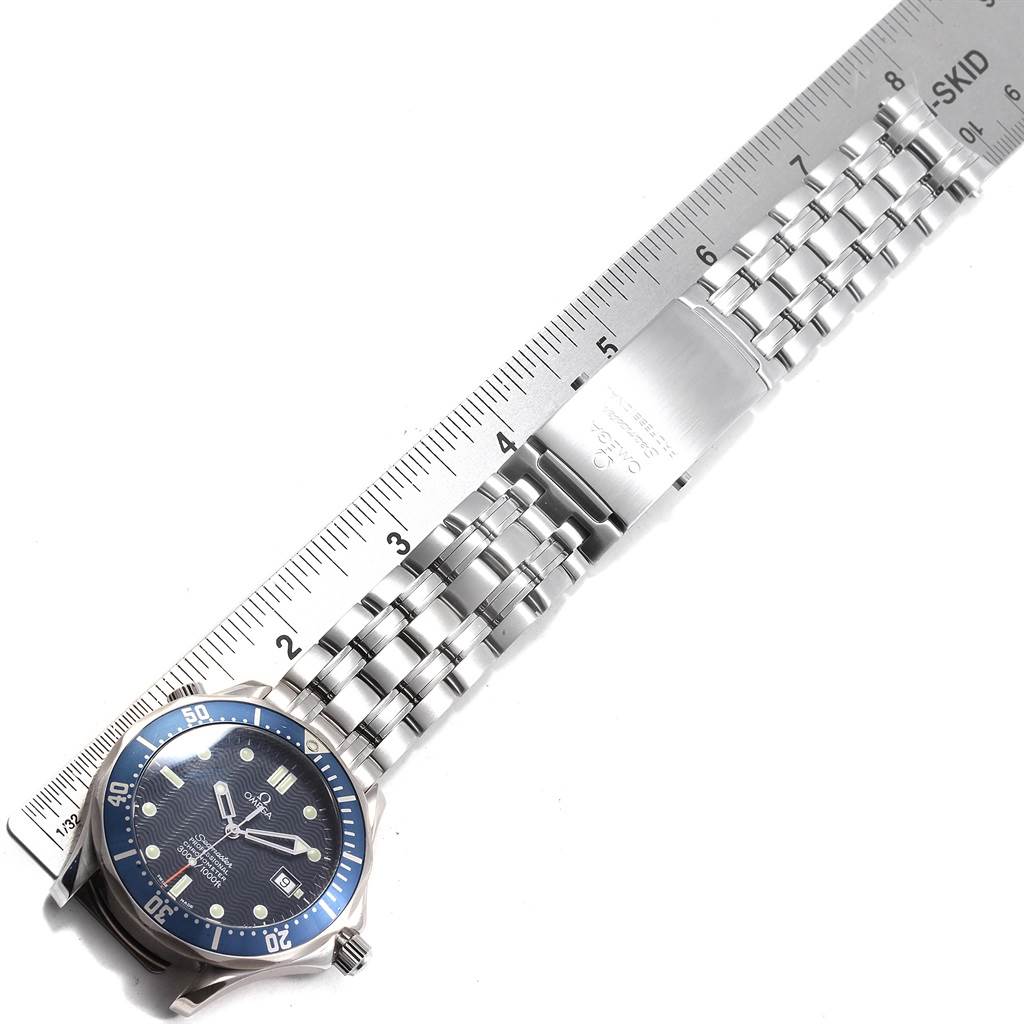 The image shows an Omega Seamaster 2531.80.00 Men's Stainless Steel Blue Dial 2531.80.00 Men's Stainless Steel Blue Dial watch laid flat, featuring its face, bezel, and metal bracelet alongside a ruler.
