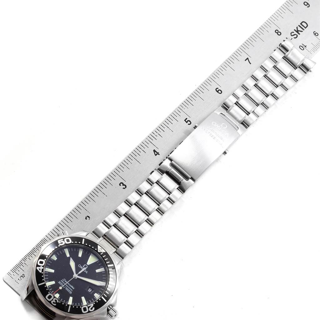 The image shows an Omega Seamaster 2264.50.00 Men
s Stainless Steel Black Dial 2264.50.00 Men
s Stainless Steel Black Dial watch laid flat with its face, bracelet, and clasp visible beside a ruler for scale.