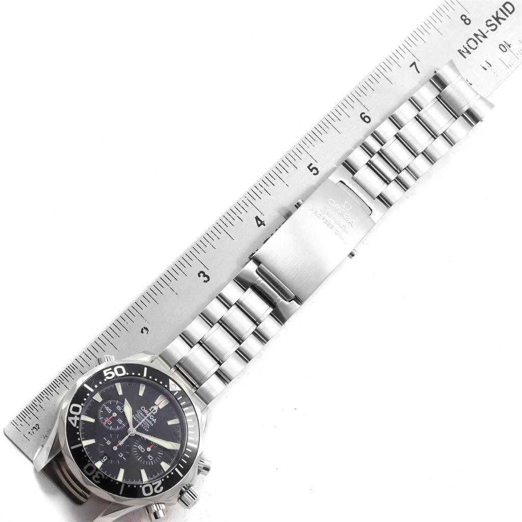 The image shows an Omega Seamaster 2594.50.00 Men
s Stainless Steel Black Dial 2594.50.00 Men
s Stainless Steel Black Dial watch laid flat, measured with a ruler, highlighting its face and metal bracelet.