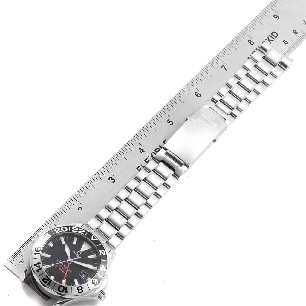 The image shows an Omega Seamaster 2234.50.00 Men
s Stainless Steel Black Dial 2234.50.00 Men
s Stainless Steel Black Dial watch laid flat next to a ruler, highlighting its bracelet length and clasp.