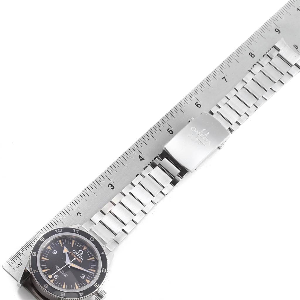 The photo shows an overhead view of an Omega Seamaster 233.32.41.21.01.001 Men
s Stainless Steel Black Dial 233.32.41.21.01.001 Men
s Stainless Steel Black Dial watch next to a metal ruler, highlighting the watch face and bracelet.