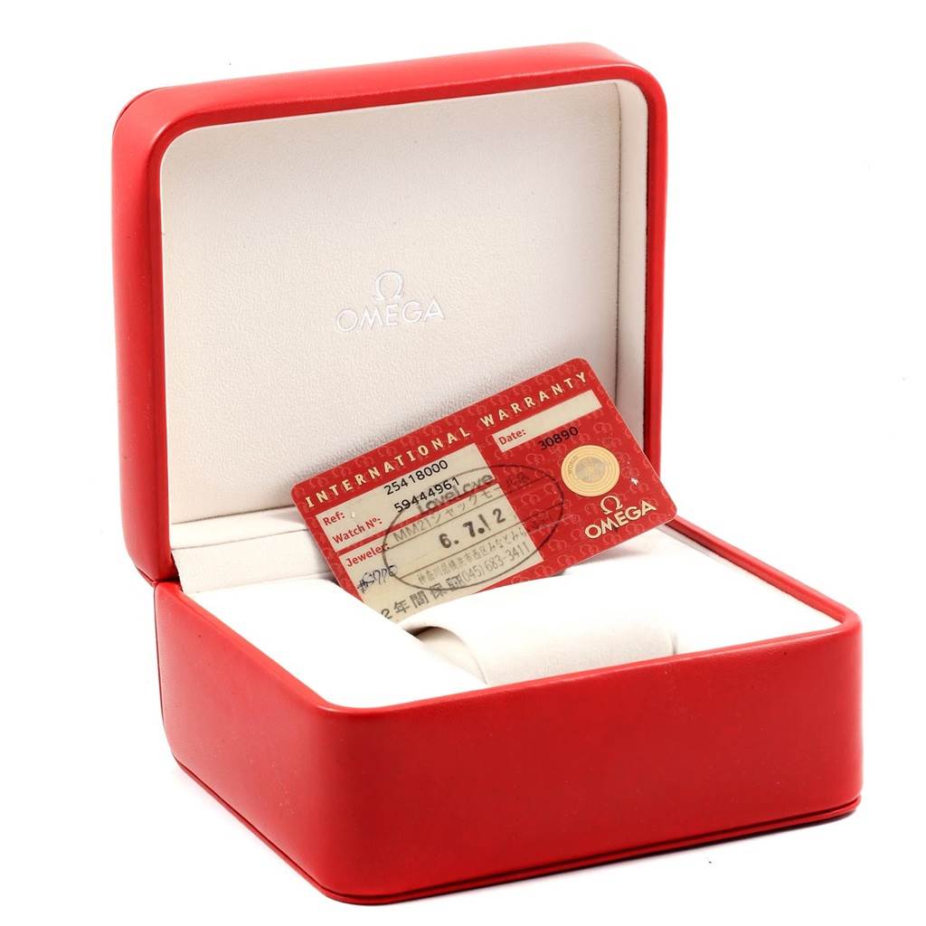 The image shows an open red Omega box for the Seamaster model, with an international warranty card inside.