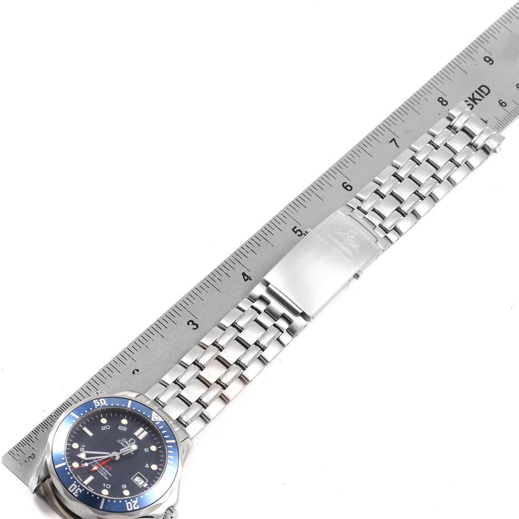 The image shows an Omega Seamaster 2535.80.00 Men
s Stainless Steel Blue Dial 2535.80.00 Men
s Stainless Steel Blue Dial watch laid flat with a ruler to measure its metal bracelet and clasp.