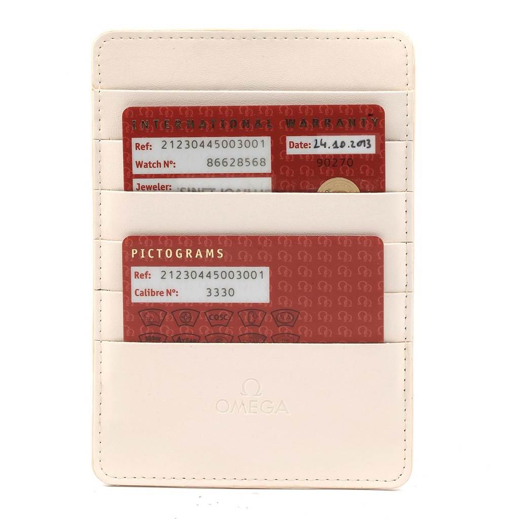 The image shows the warranty and pictogram cards for an Omega Seamaster 212.30.44.50.03.001 Men
s Stainless Steel Blue Dial 212.30.44.50.03.001 Men
s Stainless Steel Blue Dial watch, displayed in a branded cardholder.