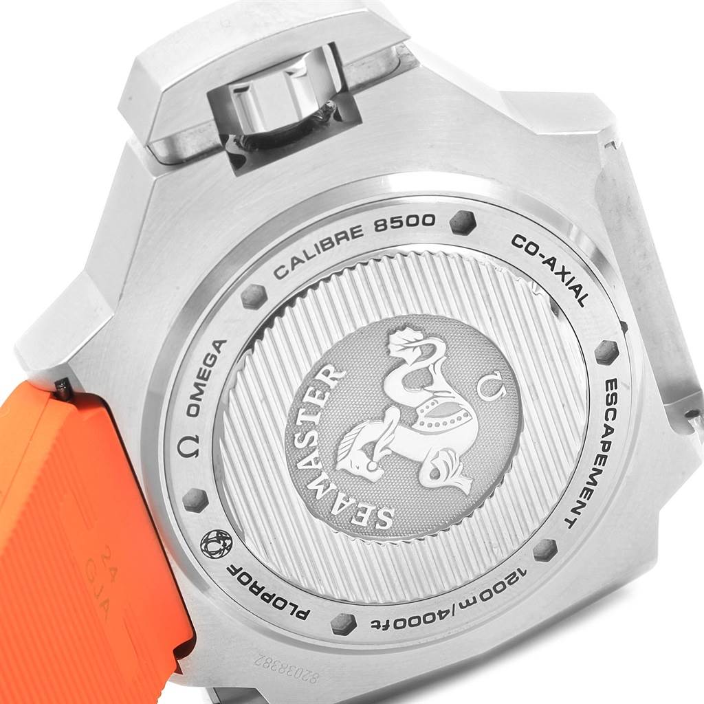 The image shows the back side of the Omega Ploprof 224.32.55.21.01.002 Men's Stainless Steel Black Dial 224.32.55.21.01.002 Men's Stainless Steel Black Dial watch, highlighting the case back, crown, and part of the orange strap.