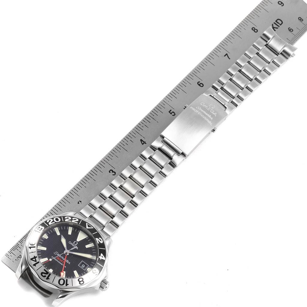 The image shows an Omega Seamaster 2536.50.00 Men's Stainless Steel Black Dial 2536.50.00 Men's Stainless Steel Black Dial watch laid flat with its stainless steel bracelet fully extended and aligned with a ruler.