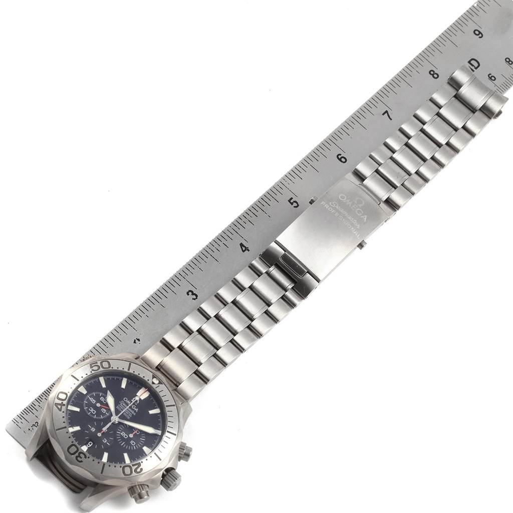 The image shows an Omega Seamaster 2293.52.00 Men's Titanium Black Dial 2293.52.00 Men's Titanium Black Dial watch laid flat with a ruler beside it for scale, displaying the dial, bezel, and metal bracelet.