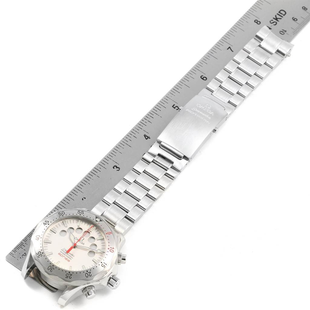 The image shows an Omega Seamaster 2595.30.00 Men
s Stainless Steel Silver Dial 2595.30.00 Men
s Stainless Steel Silver Dial watch laid flat, displaying the face, bezel, and metal bracelet with a ruler for scale.