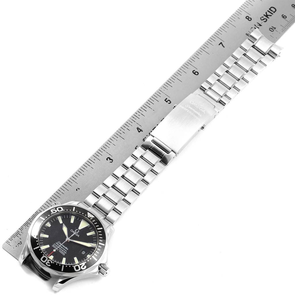 The image shows an Omega Seamaster 2254.50.00 Men
s Stainless Steel Black Dial 2254.50.00 Men
s Stainless Steel Black Dial watch placed next to a ruler, highlighting the watch face and metal bracelet.