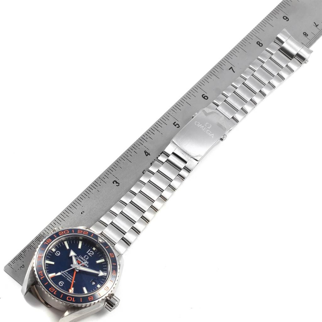 The image shows a top-down view of an Omega Seamaster 232.30.44.22.03.001 Men
s Stainless Steel Blue Dial 232.30.44.22.03.001 Men
s Stainless Steel Blue Dial watch, highlighting the face, bezel, and metal bracelet against a ruler for scale.