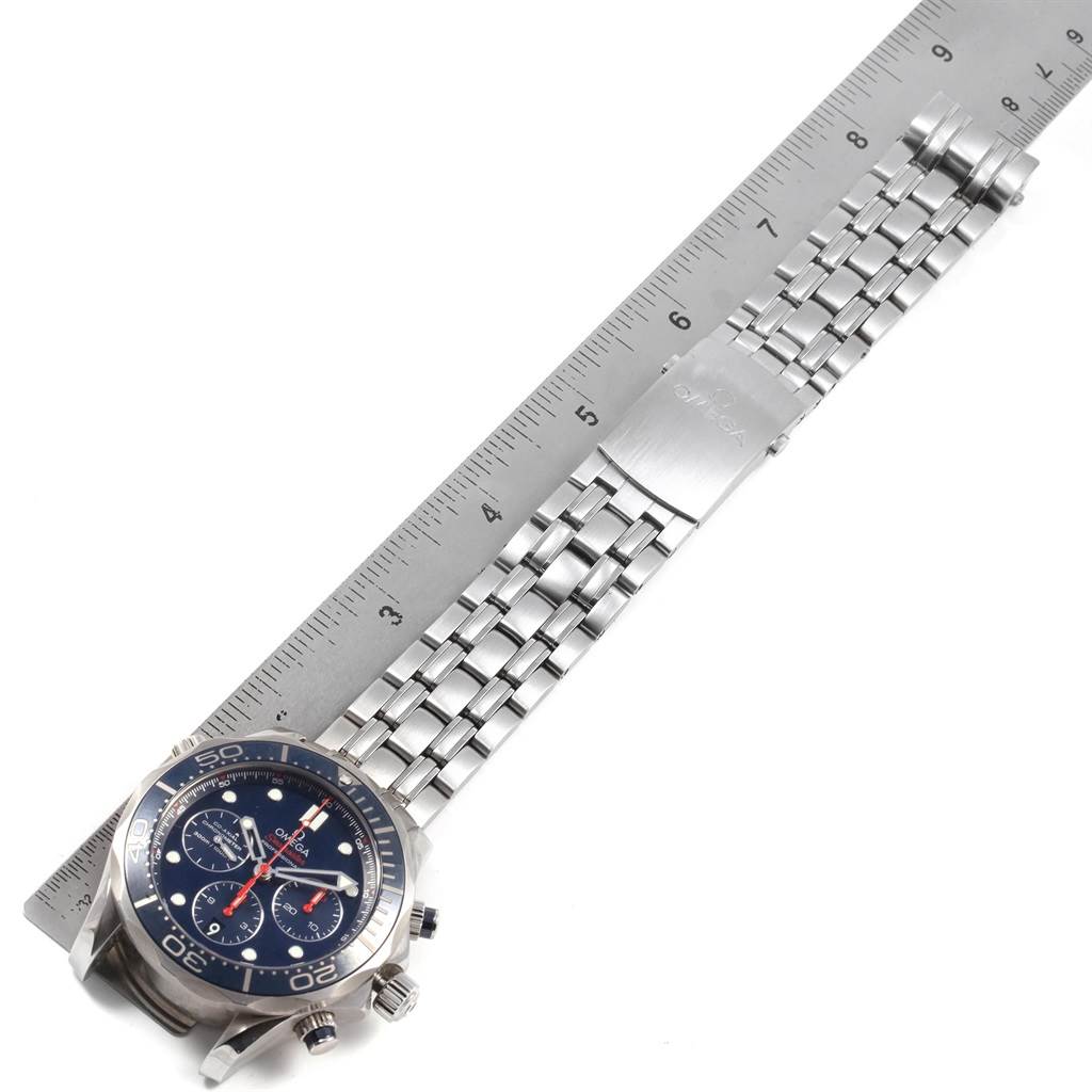 The image shows a top view of an Omega Seamaster 212.30.44.50.03.001 Men
s Stainless Steel Blue Dial 212.30.44.50.03.001 Men
s Stainless Steel Blue Dial watch and its metal bracelet next to a ruler.