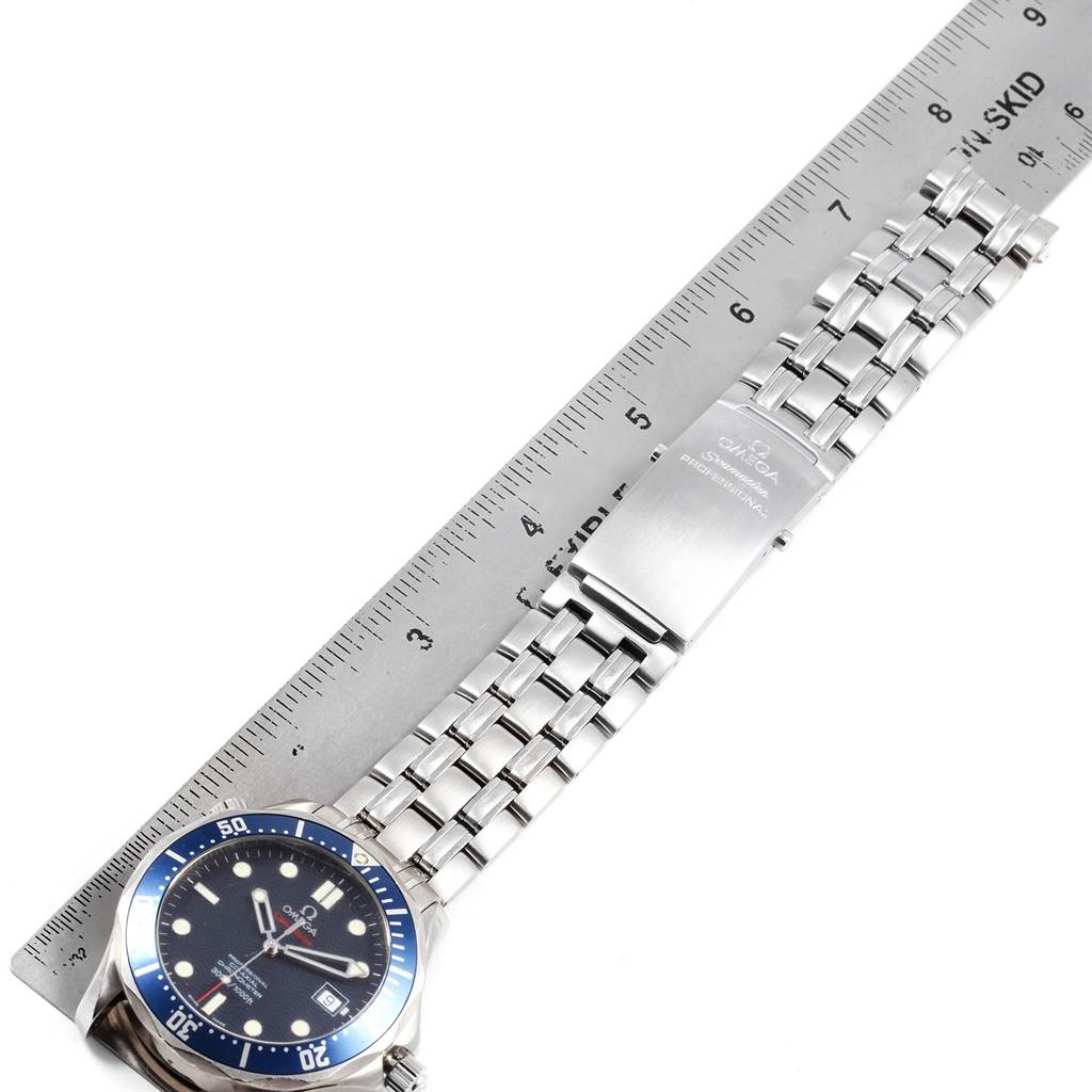 The image shows an Omega Seamaster 2220.80.00 Men's Stainless Steel Blue Dial 2220.80.00 Men's Stainless Steel Blue Dial watch laid flat with the face, bezel, and bracelet clearly visible next to a ruler.