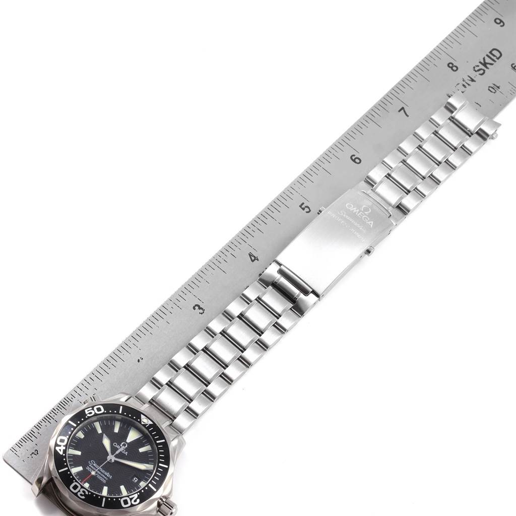 The image shows an Omega Seamaster 2262.50.00 Men
s Stainless Steel Black Dial 2262.50.00 Men
s Stainless Steel Black Dial watch laid flat next to a ruler, displaying its face and metal bracelet.