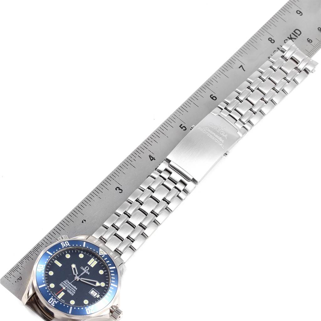 The image shows an Omega Seamaster 2531.80.00 Men
s Stainless Steel Blue Dial 2531.80.00 Men
s Stainless Steel Blue Dial watch laid flat next to a ruler, displaying its face, bracelet, and clasp.