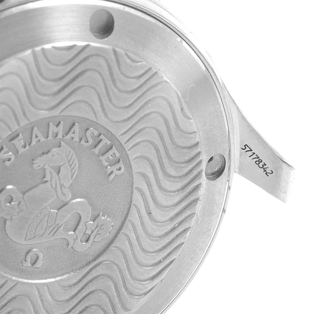 The image shows the case back of an Omega Seamaster 2262.50.00 Men
s Stainless Steel Black Dial 2262.50.00 Men
s Stainless Steel Black Dial watch at an angle, highlighting its engraved wave pattern and serial number.