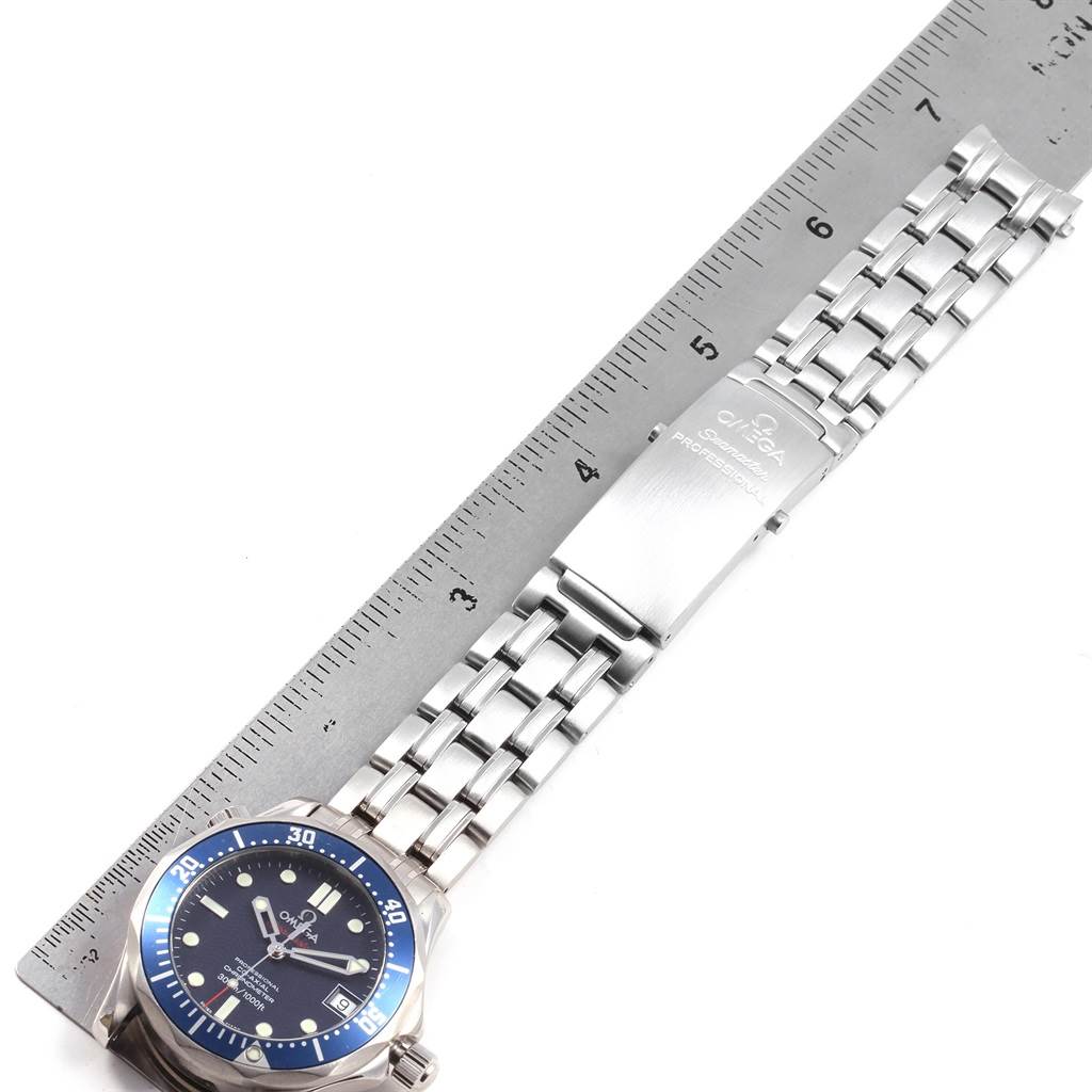 The photo shows the Omega Seamaster 2222.80.00 Men
s Stainless Steel Blue Dial 2222.80.00 Men
s Stainless Steel Blue Dial watch from a top angle, highlighting the dial, bezel, and metal bracelet alongside a ruler.