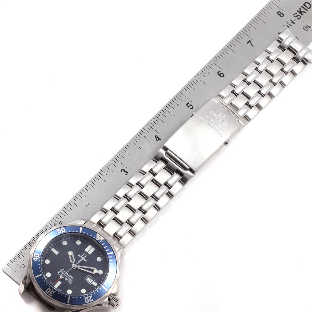 The image shows an Omega Seamaster 2541.80.00 Men
s Stainless Steel Blue Dial 2541.80.00 Men
s Stainless Steel Blue Dial watch laid flat alongside a ruler, displaying its face, bracelet, and clasp.