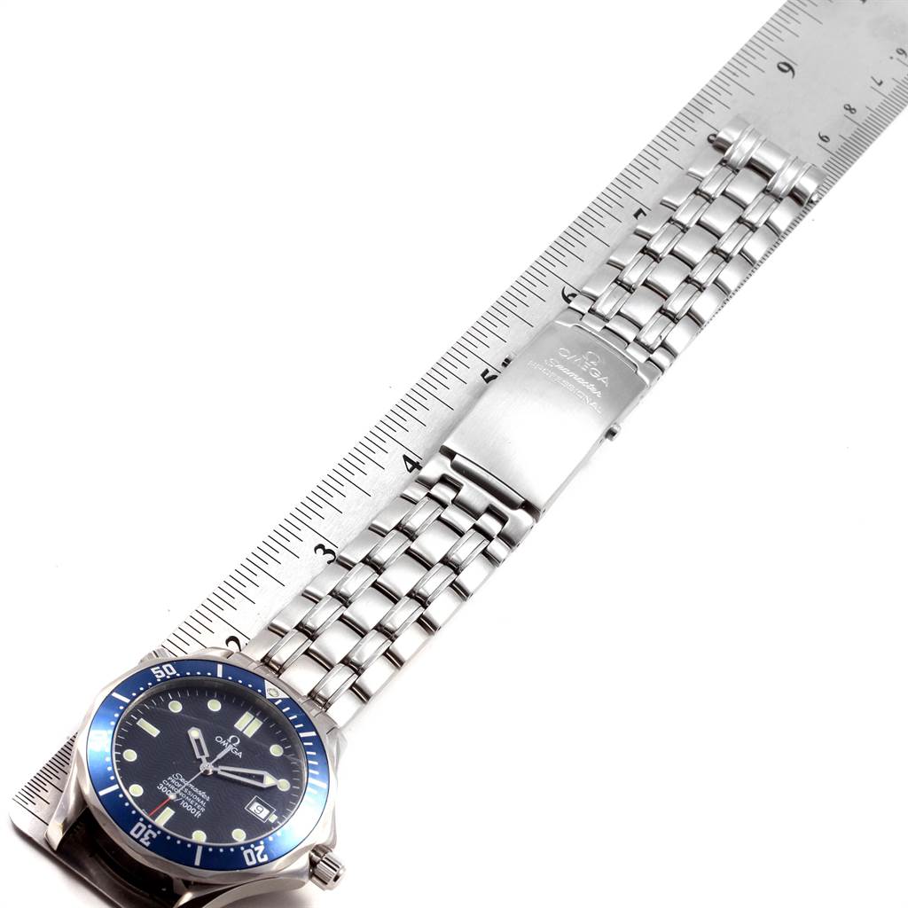The image shows an Omega Seamaster 2531.80.00 Men
s Stainless Steel Blue Dial 2531.80.00 Men
s Stainless Steel Blue Dial watch laid out flat beside a ruler, displaying its dial and metal bracelet.