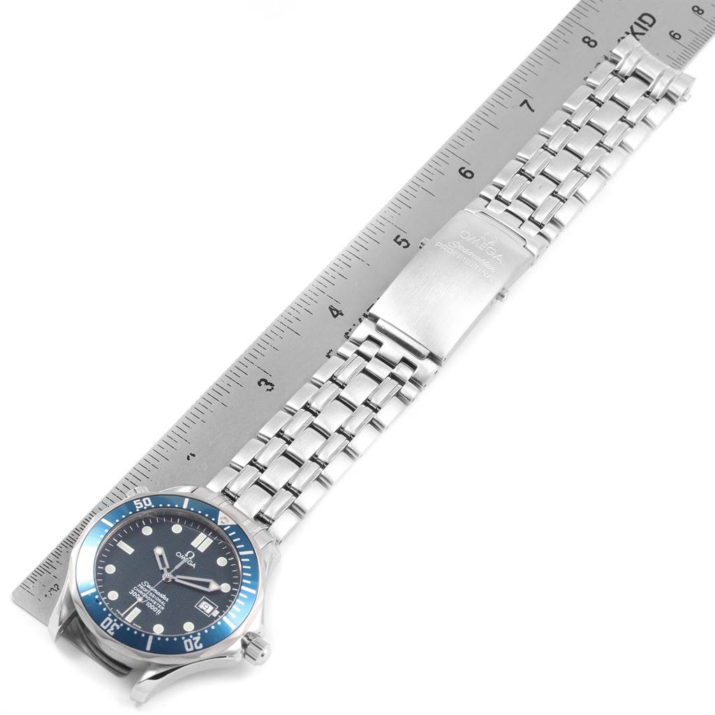 The image shows an Omega Seamaster 2531.80.00 Men
s Stainless Steel Blue Dial 2531.80.00 Men
s Stainless Steel Blue Dial watch laid flat next to a ruler, displaying the face, bezel, and bracelet.